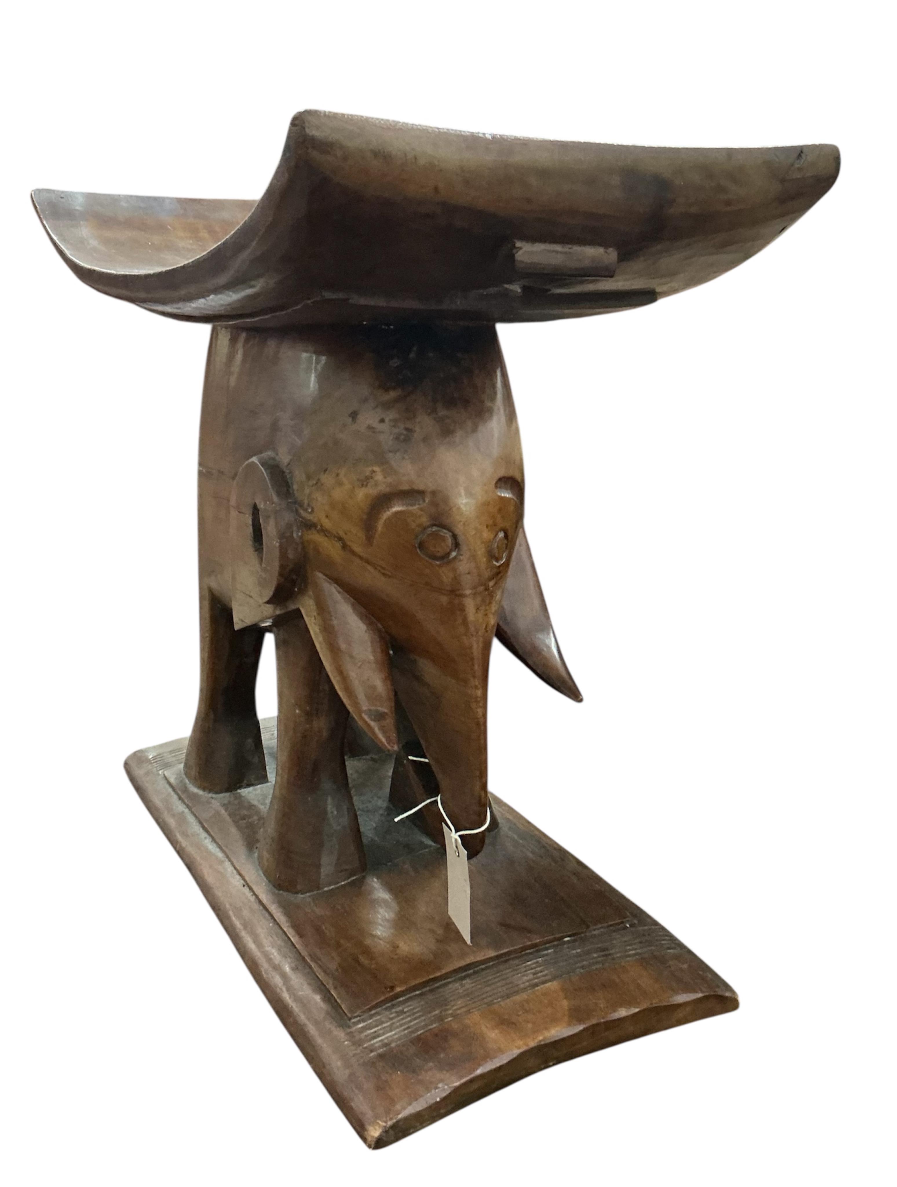 An African elephant carved Ashanti style stool, width 60cm, depth 30cm, height 51cm